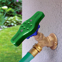 Green oblong cap screwed down on top of a standard round outdoor water faucet handle
