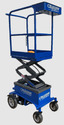A blue 4-wheeled drivable scissor-lift cart with a safety-railed platform at the top for a person to stand in.