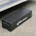 A portable black block used as a step to get into a vehicle.