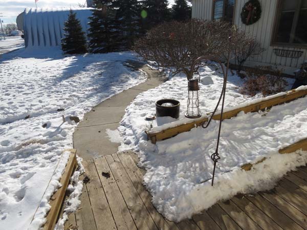 Pictured from the second floor of the house is a snow-cleared pathway that runs past the fueling area to the workshop/equipment and other farmstead buildings.