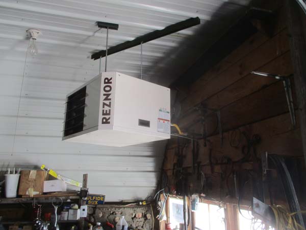 Pictured in this workshop is a ceiling-suspended natural gas-powered heat heater.