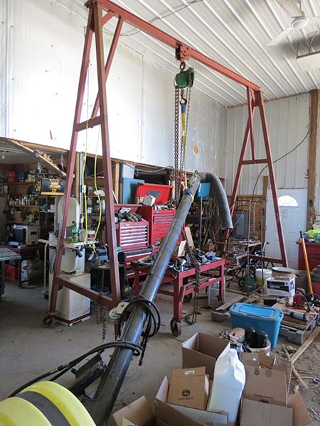 Pictured is the in-workshop A-framed/trolley/hoist gentry crane with worktable underneath as described in text and caption.